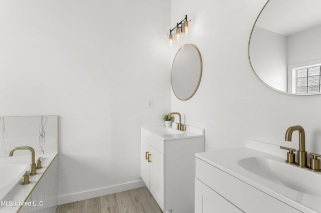14789 Nassau Dr, Biloxi, MS 39532 - bathroom with wood finished floors, two vanities, and a bathtub