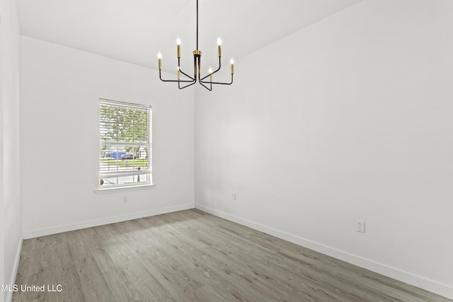 14789 Nassau Dr, Biloxi, MS 39532 - spare room featuring wood finished floors and a chandelier