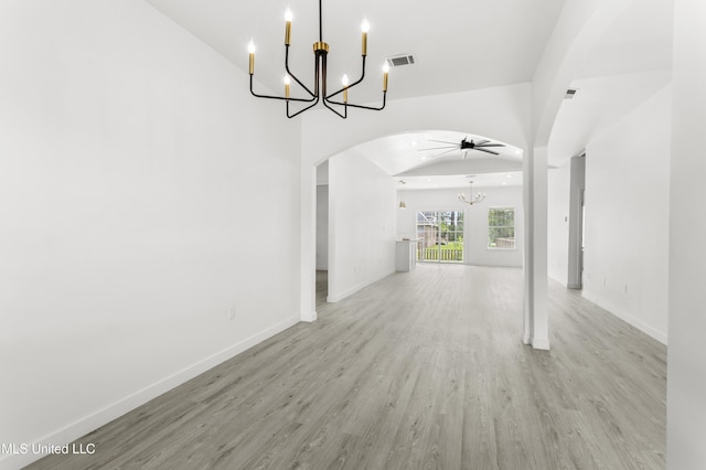 14789 Nassau Dr, Biloxi, MS 39532 - unfurnished living room with a chandelier, arched walkways, wood finished floors, and ceiling fan