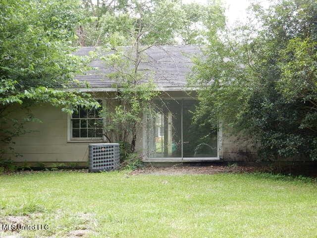 1510 Springridge Dr, Jackson, MS 39211 - rear view of property with central AC unit and a yard