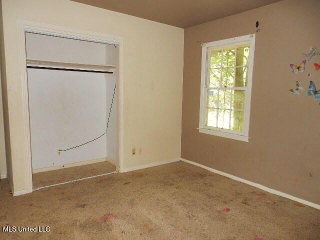 1510 Springridge Dr, Jackson, MS 39211 - unfurnished bedroom with carpet flooring, baseboards, and a closet