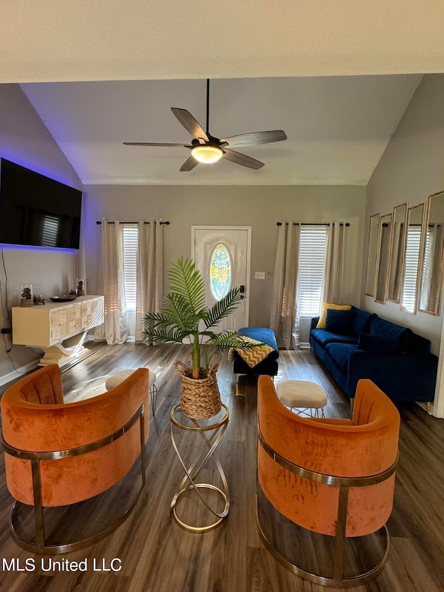 living room featuring ceiling fan, vaulted ceiling, plenty of natural light, and dark hardwood / wood-style floors