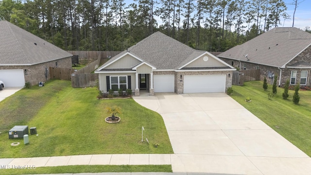 ranch-style home featuring an attached garage, fence, driveway, and a front yard