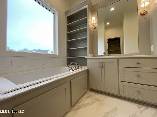 bathroom with vanity, built in shelves, and a bathing tub