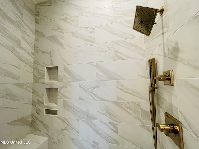 bathroom with a tile shower