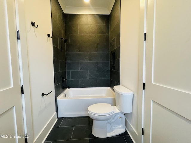 bathroom with tiled shower / bath, tile patterned floors, and toilet