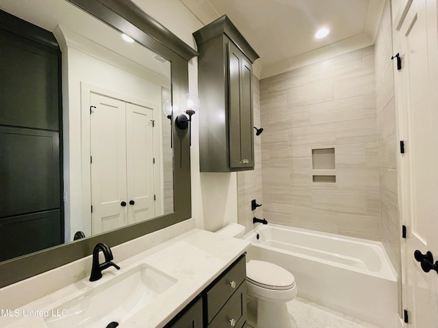 full bathroom with vanity, tiled shower / bath combo, and toilet