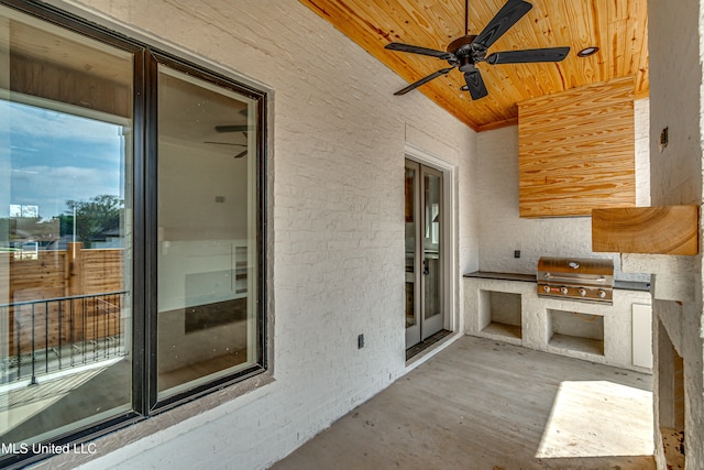 view of patio with an outdoor kitchen, a grill, and ceiling fan