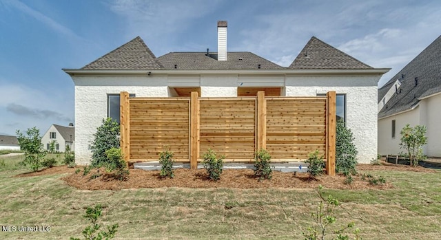 rear view of property with a yard