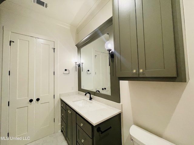 bathroom with vanity and toilet