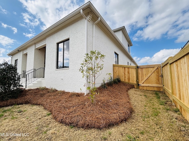 view of side of home featuring a yard