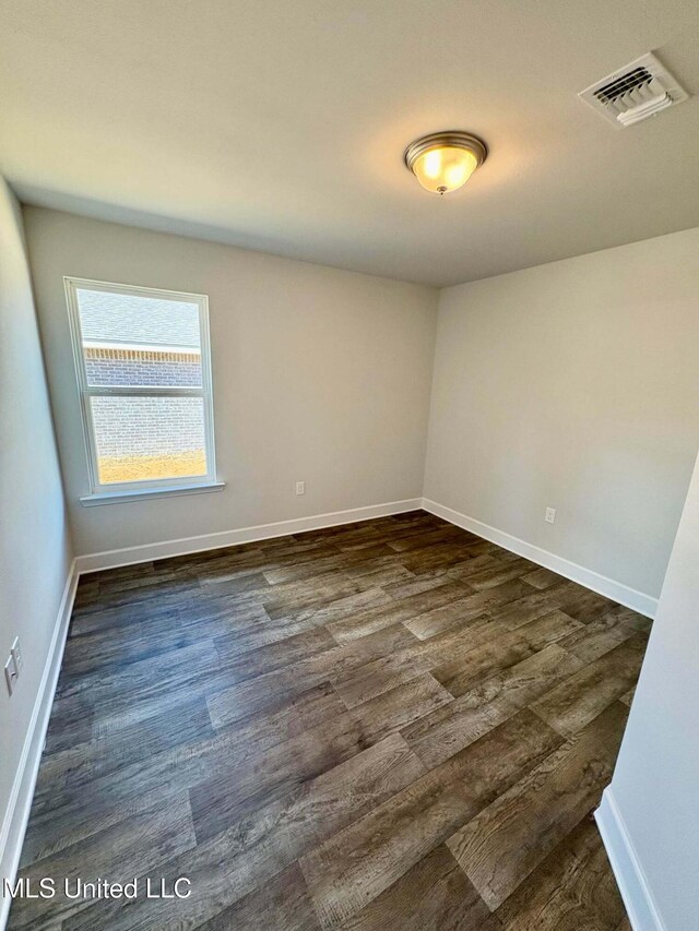 18085 Tiffany Renee Dr, Gulfport, MS 39503 - empty room with visible vents, dark wood-style flooring, and baseboards