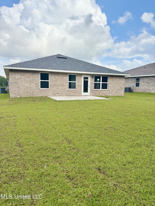 18085 Tiffany Renee Dr, Gulfport, MS 39503 - rear view of property featuring a lawn, a patio, and central AC