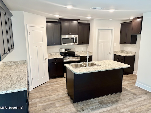 18085 Tiffany Renee Dr, Gulfport, MS 39503 - kitchen with a sink, light wood-style floors, light countertops, stainless steel appliances, and visible vents