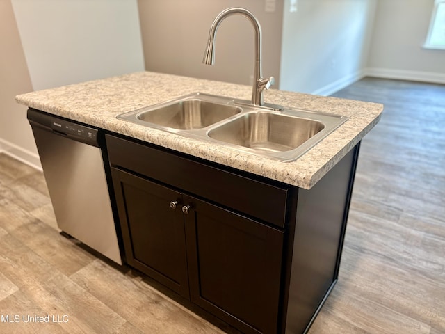 18085 Tiffany Renee Dr, Gulfport, MS 39503 - kitchen featuring dark brown cabinetry, baseboards, light countertops, a sink, and dishwasher