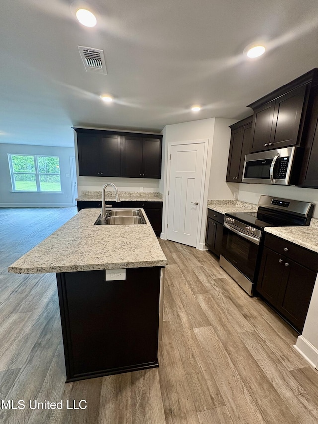 18085 Tiffany Renee Dr, Gulfport, MS 39503 - kitchen featuring stainless steel appliances, visible vents, a sink, and light wood finished floors