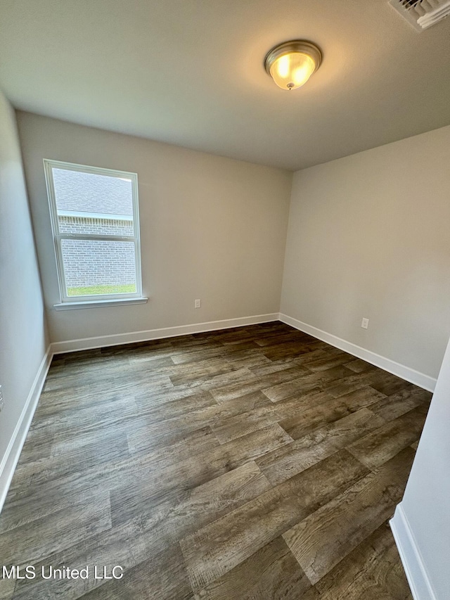 18085 Tiffany Renee Dr, Gulfport, MS 39503 - empty room featuring visible vents, dark wood-style flooring, and baseboards