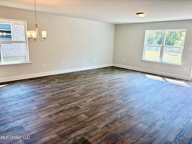 18085 Tiffany Renee Dr, Gulfport, MS 39503 - unfurnished room featuring baseboards, a notable chandelier, and dark wood-type flooring
