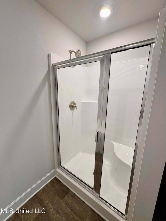 18085 Tiffany Renee Dr, Gulfport, MS 39503 - bathroom with baseboards, a shower stall, and wood finished floors
