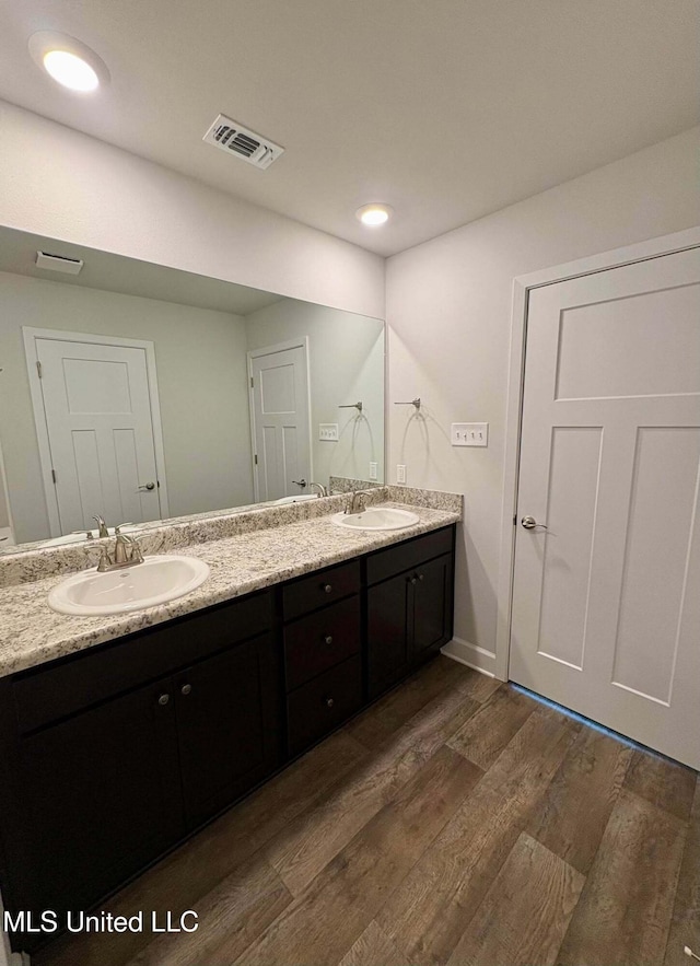 18085 Tiffany Renee Dr, Gulfport, MS 39503 - bathroom with a sink, double vanity, wood finished floors, and visible vents