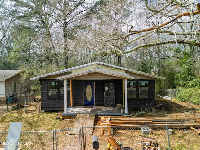 view of front of property with fence private yard and covered porch