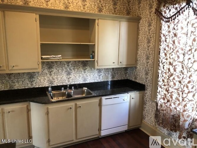 305 N Rankin St, Natchez, MS 39120 - kitchen with cream cabinetry, white dishwasher, dark hardwood / wood-style floors, and sink