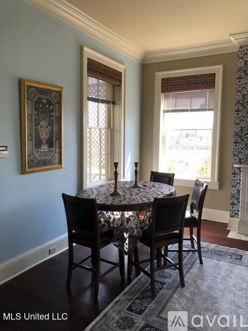 305 N Rankin St, Natchez, MS 39120 - dining area with a healthy amount of sunlight, dark hardwood / wood-style floors, and ornamental molding