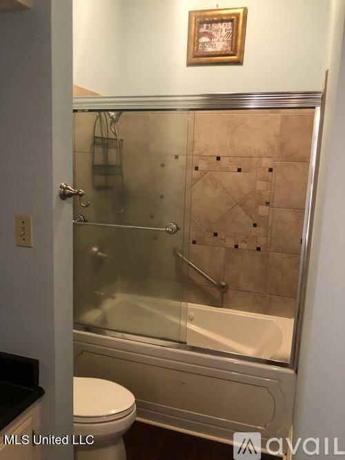 305 N Rankin St, Natchez, MS 39120 - full bathroom with vanity, bath / shower combo with glass door, and toilet