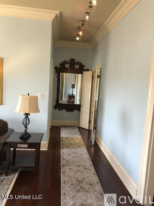 305 N Rankin St, Natchez, MS 39120 - hallway with dark hardwood / wood-style flooring, crown molding, and track lighting