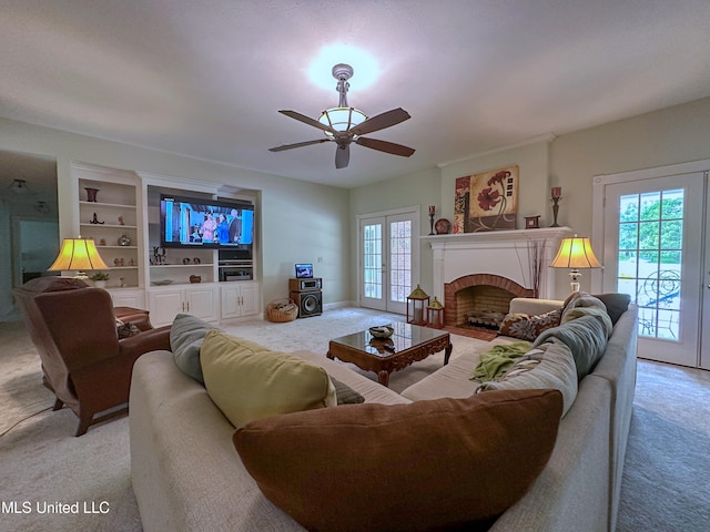 living room with french doors, a fireplace, ceiling fan, and light colored carpet