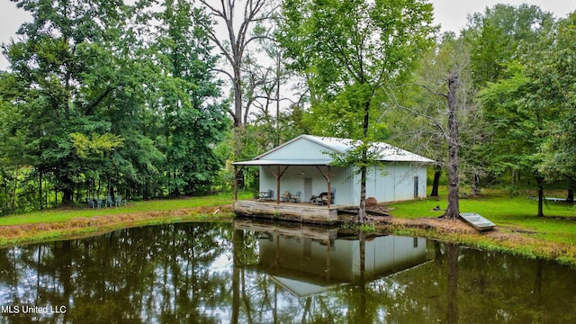 exterior space featuring a yard and a water view