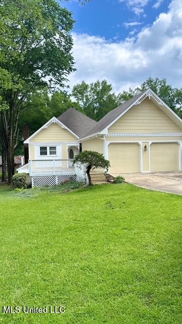 202 Kilford Ct, Madison, MS 39110 - view of front of house with concrete driveway, an attached garage, a front yard, and a porch