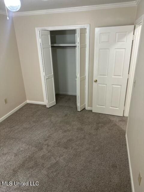 202 Kilford Ct, Madison, MS 39110 - unfurnished bedroom with dark carpet, crown molding, baseboards, and a closet