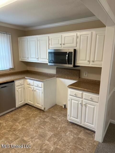 202 Kilford Ct, Madison, MS 39110 - kitchen with appliances with stainless steel finishes, ornamental molding, white cabinets, and dark countertops