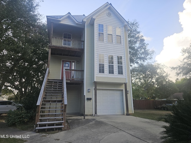 view of front of property featuring a garage and a balcony