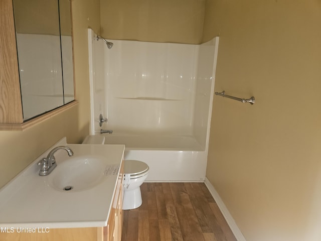 full bathroom featuring toilet, shower / bath combination, hardwood / wood-style floors, and vanity