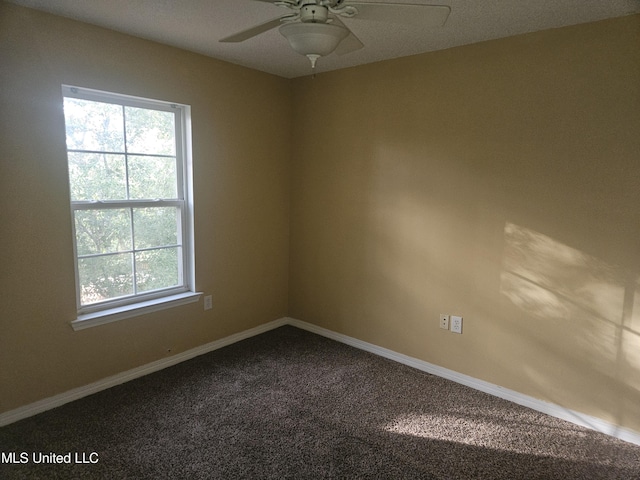 carpeted spare room featuring ceiling fan