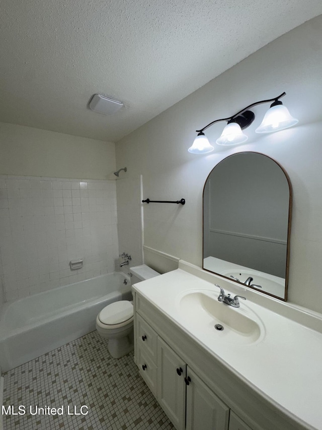 full bathroom featuring tile patterned flooring, vanity, a textured ceiling, and toilet