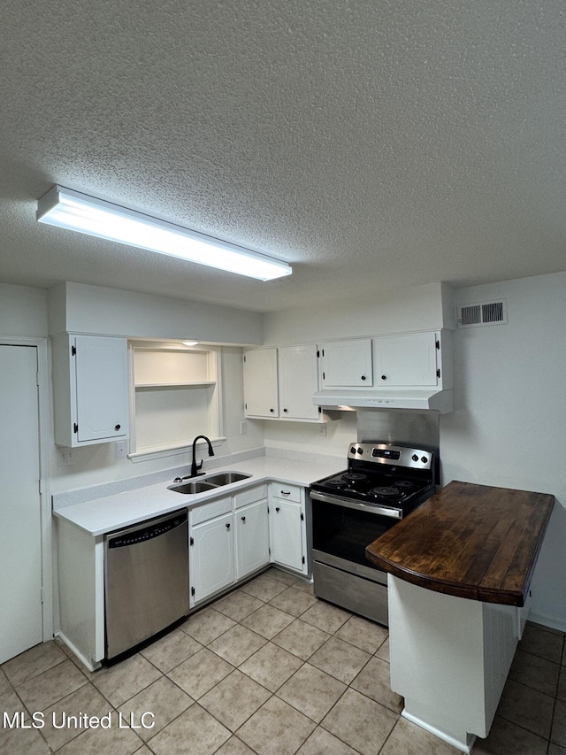 kitchen with sink, white cabinets, stainless steel appliances, and a textured ceiling