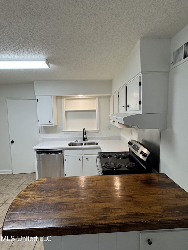 kitchen with white cabinets, sink, appliances with stainless steel finishes, and a textured ceiling