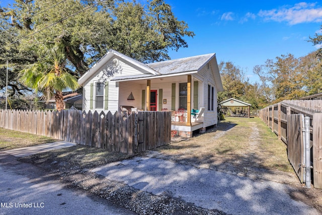 bungalow-style house with a carport and a porch