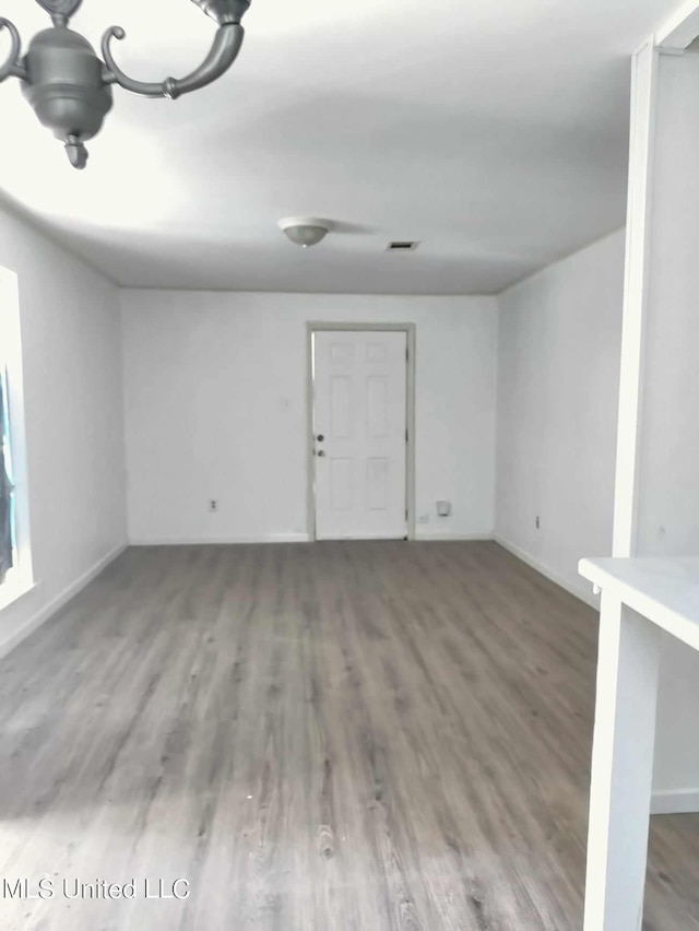 unfurnished room with wood finished floors and baseboards