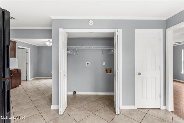 laundry area featuring washer hookup, electric dryer hookup, light tile patterned flooring, and ornamental molding