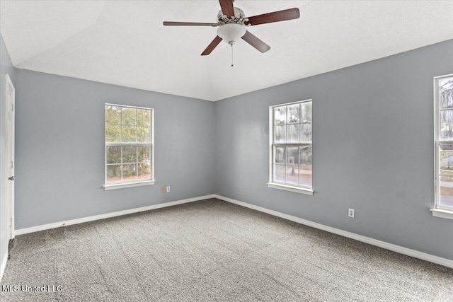 unfurnished room featuring ceiling fan, plenty of natural light, and lofted ceiling