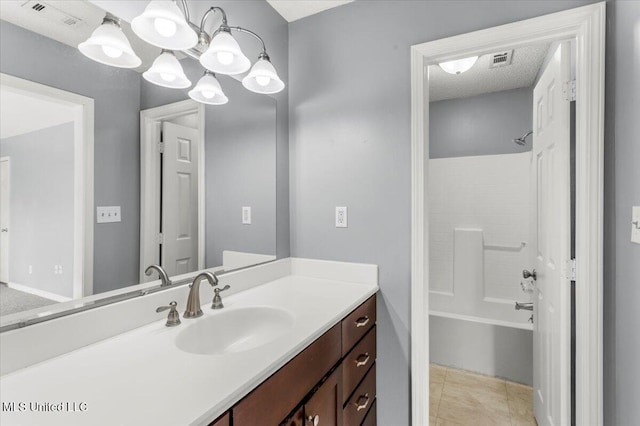 bathroom featuring an inviting chandelier, tile patterned floors, a textured ceiling,  shower combination, and vanity