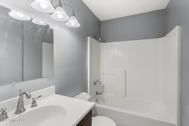 full bathroom featuring vanity, shower / bathtub combination, toilet, and a textured ceiling