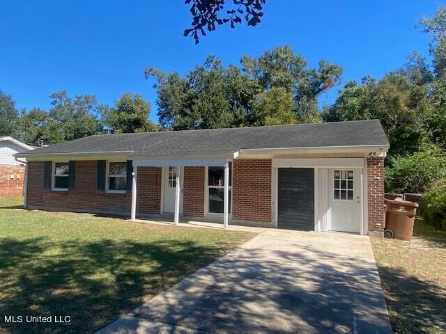 ranch-style home with a front yard and a garage