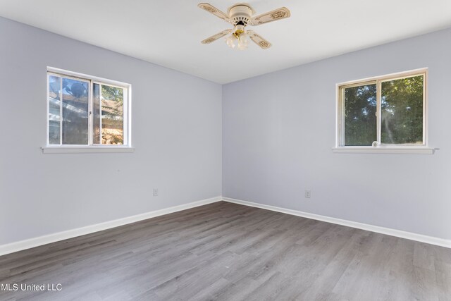 empty room featuring hardwood / wood-style floors and ceiling fan