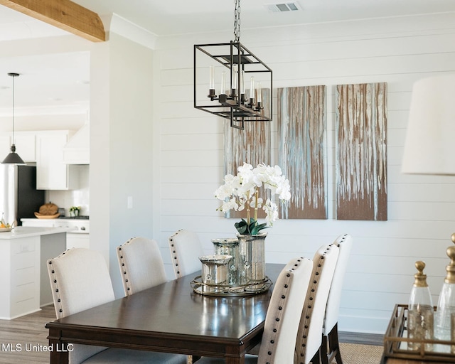 16043 W Dedeaux Rd, Gulfport, MS 39503 - dining area featuring a chandelier, wood finished floors, and wooden walls