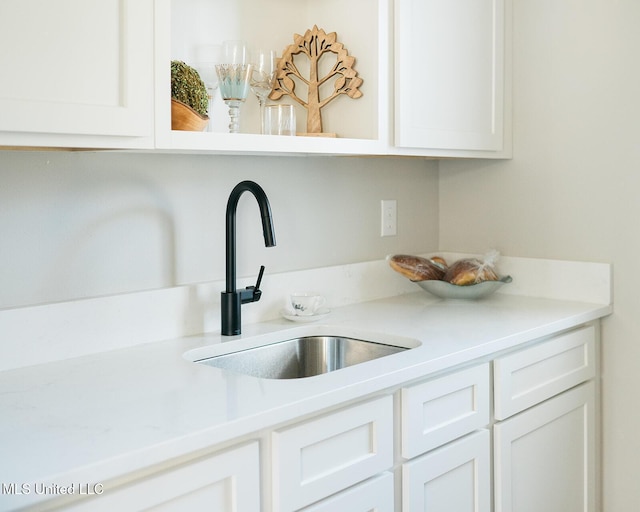 16043 W Dedeaux Rd, Gulfport, MS 39503 - kitchen view of white cabinetry, light countertops, and open shelves